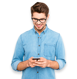 Young man smiling, looking down at his mobile phone